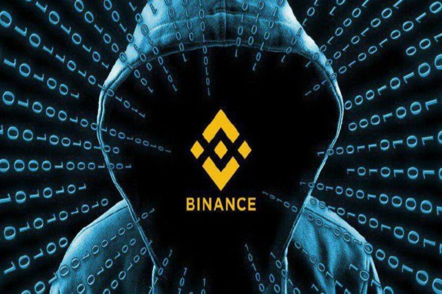 Logo de Binance en el hueco de una capucha de sudadera de un hacker