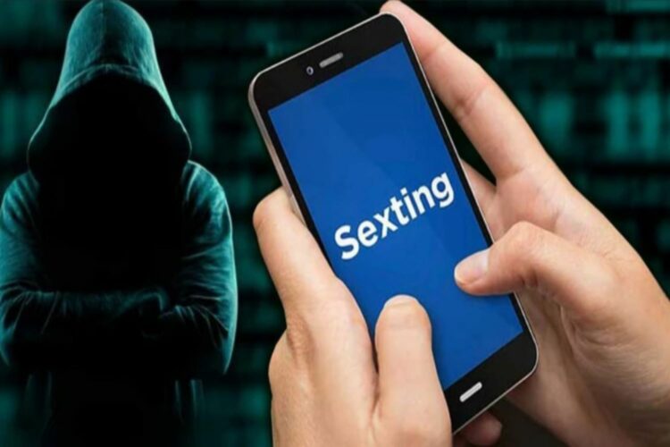 A la derecha dos manos sostienen un móvil con la palabra "Sexting" en blanco sobre un fondo azul. A la izquierda, un hacker encapuchado